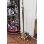 Telescopic brass corinthian column standard lamp on claw feet.