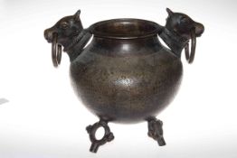 Islamic engraved bronze pot raised on three ring style feet with bull and ring handles.