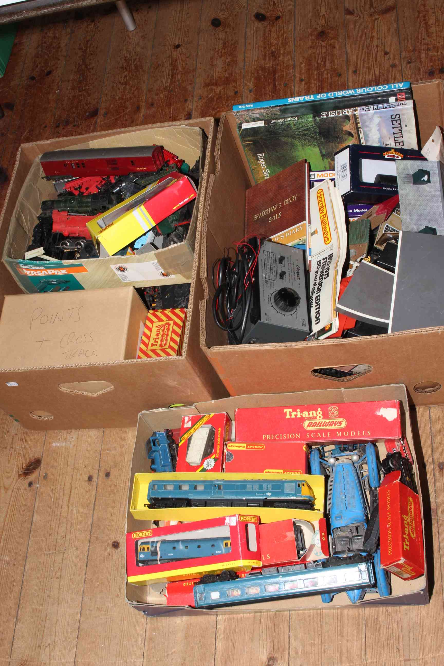 Three boxes of Hornby trains and others.