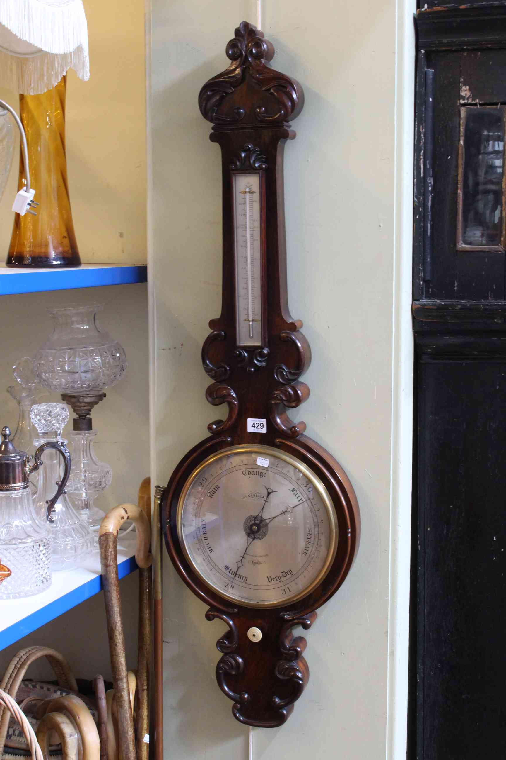 Antique rosewood banjo barometer having silvered dial, signed L. Casella, London.