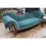 Victorian mahogany scroll end settee in green buttoned fabric.