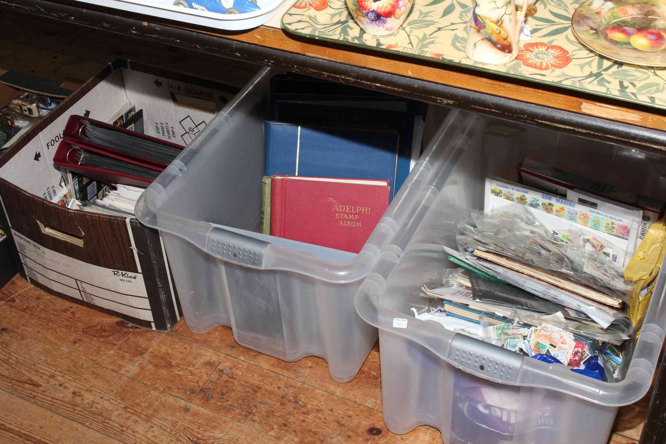 Three boxes of first day covers, loose stamps and stamps in albums.