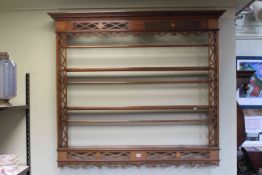 Edwardian mahogany and fretwork three tier Delft rack, 135cm by 119cm.