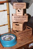 Five graduated wood 'Hogwarts School' wooden crates and Michelin clock.