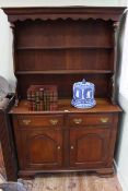 Oak shelf back dresser having two arched fielded panel doors on ogee bracket feet, 116.5cm by 189cm.