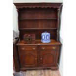 Oak shelf back dresser having two arched fielded panel doors on ogee bracket feet, 116.5cm by 189cm.