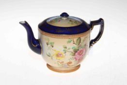 Carlton Ware teapot with flowers on shaded ground.