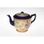 Carlton Ware teapot with flowers on shaded ground.