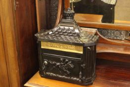 Black and gilt wall mountable letter box.