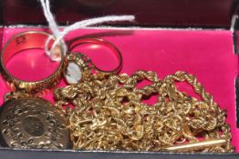 Box with gold chains, rings and locket.