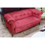 Edwardian settee in red buttoned fabric.