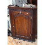 Georgian oak corner wall cabinet having arched fielded panel door, 81cm by 98.5cm.