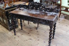 Victorian carved oak side table having a drawer to one end and raised on bobbin legs, 122cm by 77cm.