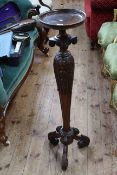 Carved mahogany torchere having tapering pedestal to triform base, 107.5cm tall.