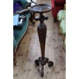 Carved mahogany torchere having tapering pedestal to triform base, 107.5cm tall.