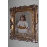 Ornate gilt framed portrait of a child, 100cm by 85cm overall.