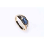 9 carat gold and sapphire ring, the rectangular sapphire flanked by rows of small diamonds, size W.