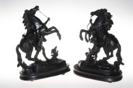 Pair of Spelter Marley horses and warriors on wooden plinths, 33cm high.