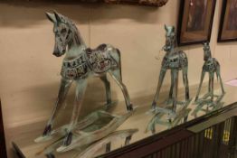 Set of three graduated wooden model rocking horses.