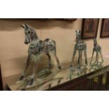 Set of three graduated wooden model rocking horses.