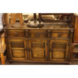 Oak three door sideboard and mahogany two door cocktail cabinet.