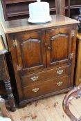 Titchmarsh & Goodwin English Oak cabinet having two arched fielded panel doors above two drawers,