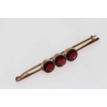 9 carat gold three stone garnet bar brooch.