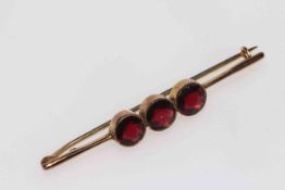 9 carat gold three stone garnet bar brooch.