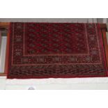 Red ground Bokhara style rug 1.90 by 1.35.