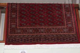 Red ground Bokhara style rug 1.90 by 1.35.