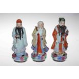 Set of three Chinese polychrome figures of elders, signed inside base, 21/22cm.