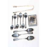 Silver teaspoons, tongs and Sherry label.