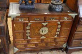 Oriental side cabinet having four short drawers above two central cupboard doors, 97cm by 80cm.