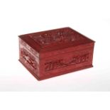 Chinese red lacquered carved wood box, with panels depicting figure in settings, 23cm across.