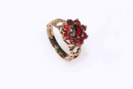 Garnet cluster ring set in 9 carat gold, size M.