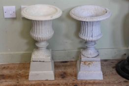 Pair small cast campana style garden urns on stands, 51cm by 28cm diameter.