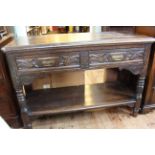 Victorian carved oak dumb waiter, the hinged top above two drawers with undershelf on turned legs,