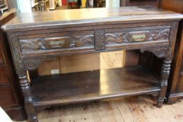 Victorian carved oak dumb waiter, the hinged top above two drawers with undershelf on turned legs,