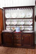 Georgian oak dresser and Delft rack having three central drawers flanked by two arched fielded