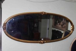 Large gilt oval framed wall mirror, 72cm by 172cm overall.