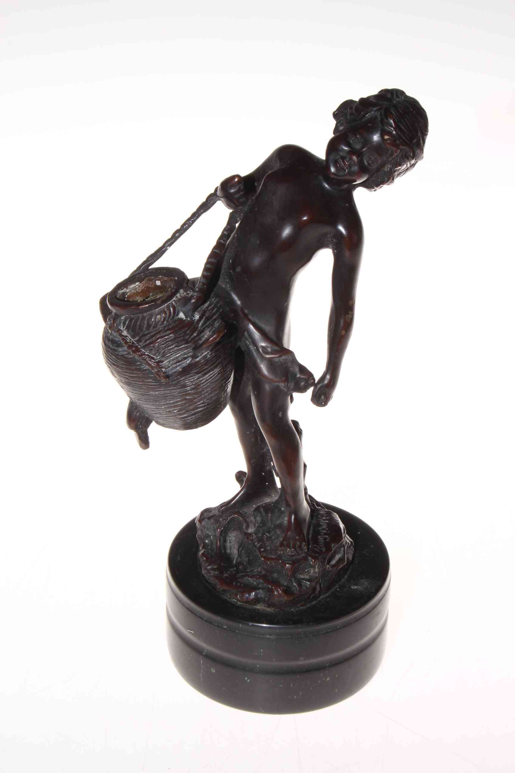 Bronze of child with basket and bird, signed on base, 27cm.