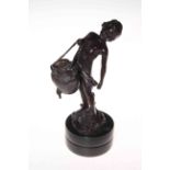 Bronze of child with basket and bird, signed on base, 27cm.