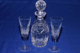 Waterford Crystal decanter and two champagne flutes.