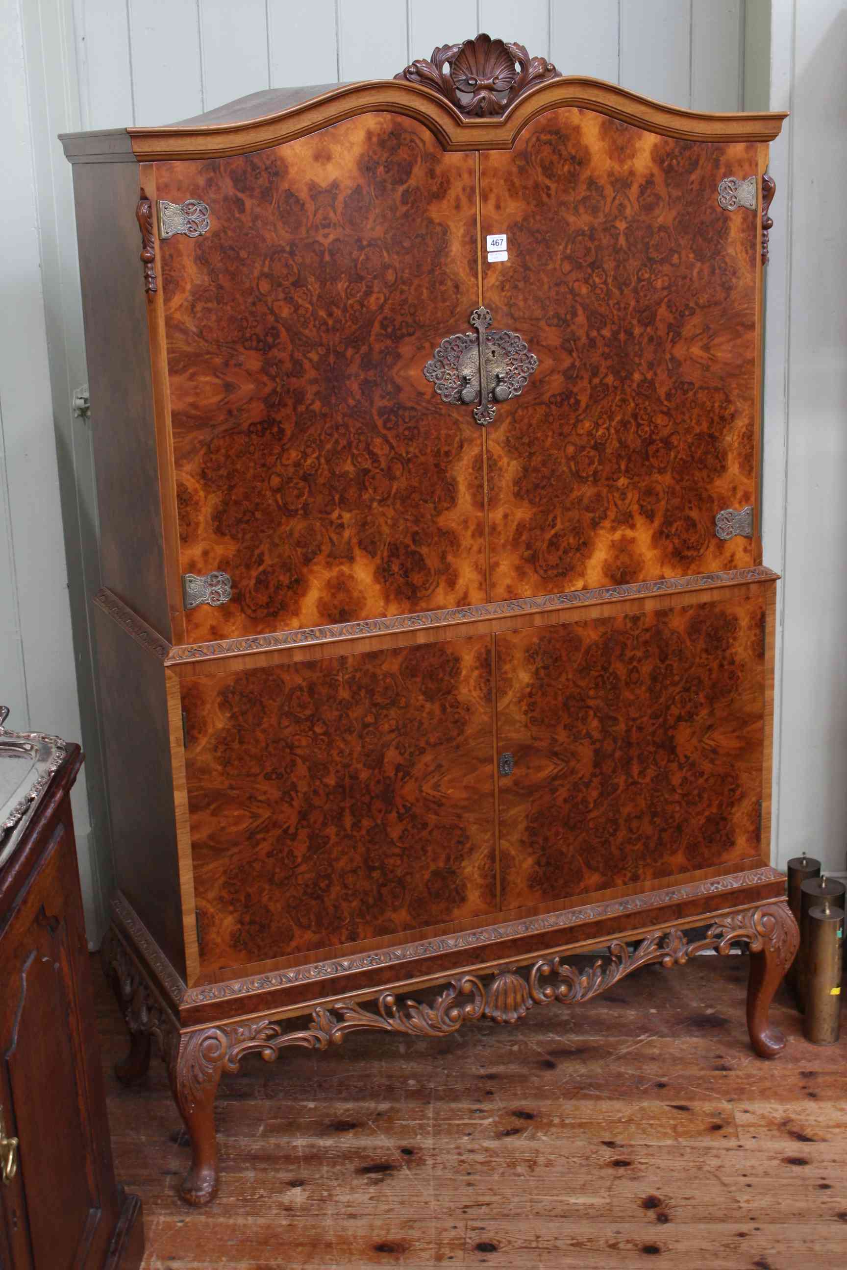 Burr walnut arched top four door cocktail cabinet on cabriole legs, 172cm by 111cm.