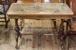 Victorian figural walnut fold top card table on turned pillars to four scrolled legs joined by