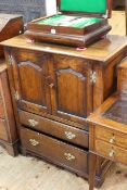 Titchmarsh & Goodwin English oak cabinet having two arched fielded panel doors above two drawers,