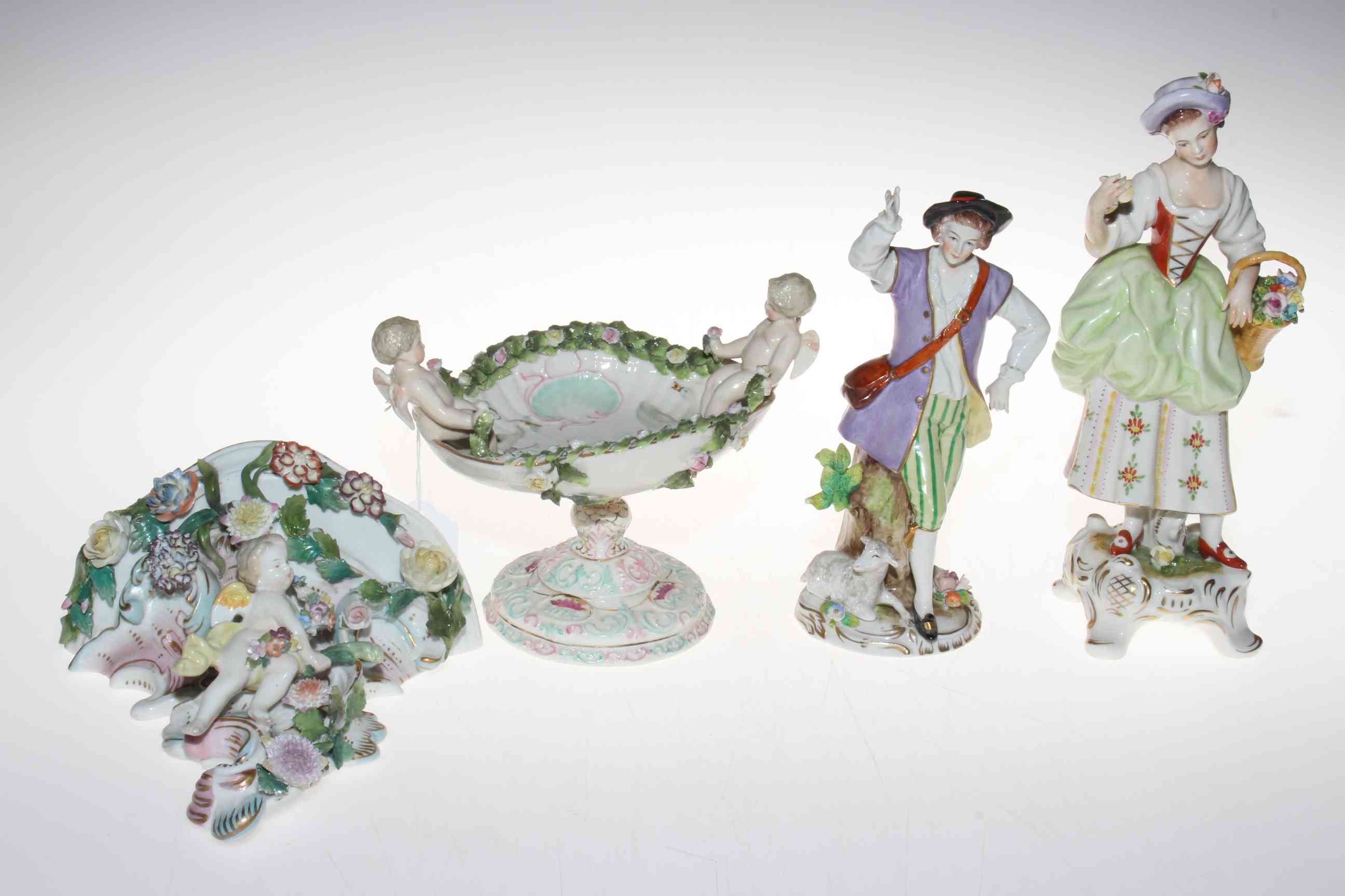 Four pieces of ornate Continental porcelain.