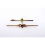 Two 9 carat gold tie pins each set with gemstone.