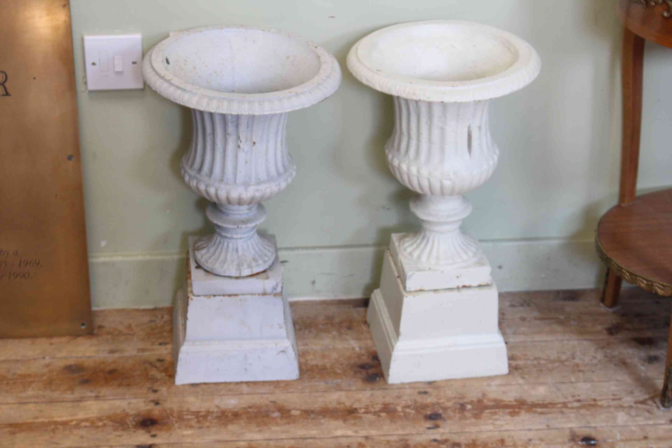 Pair small cast campana style garden urns on stands, 51cm by 28cm diameter.