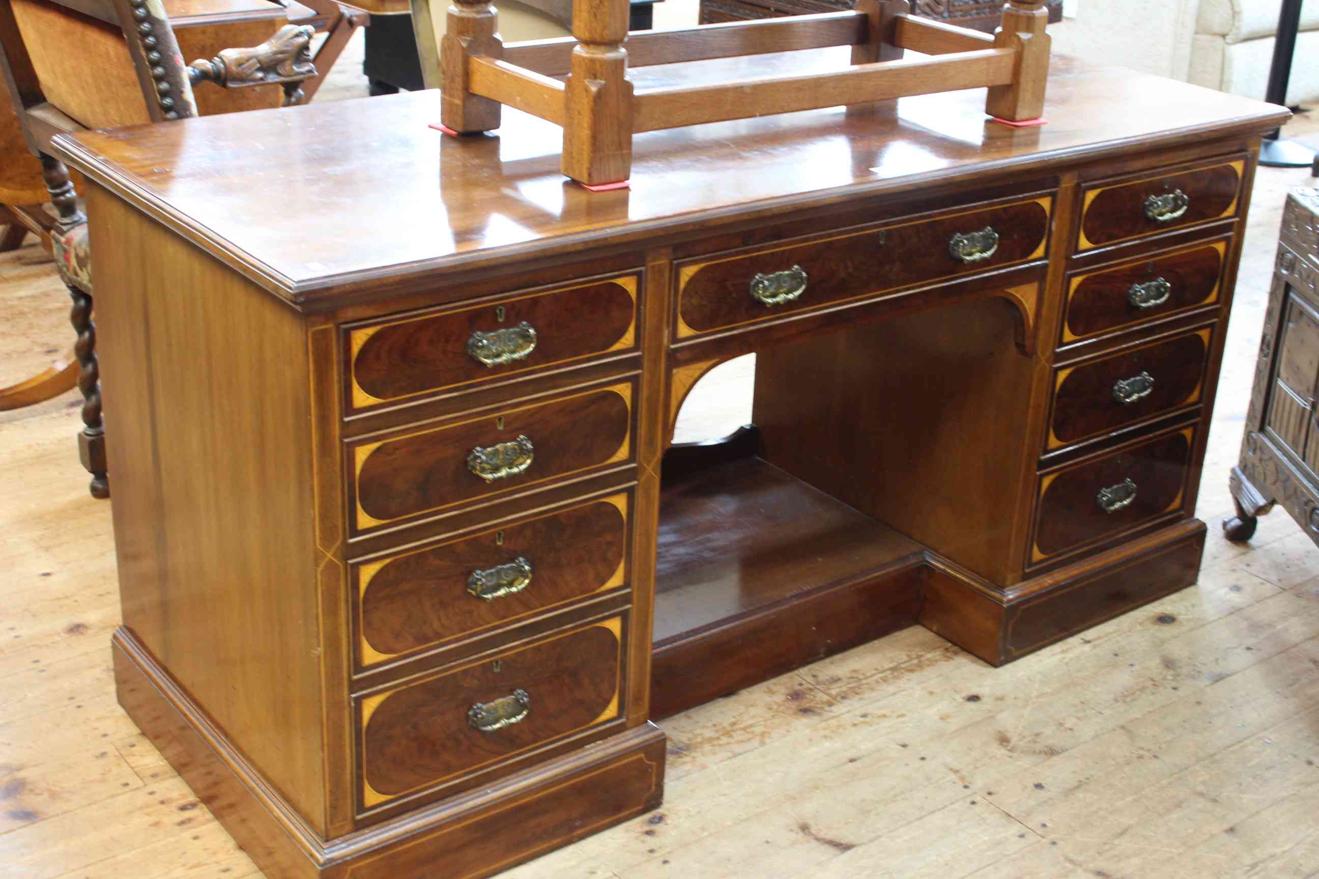 Late Victorian mahogany and satinwood nine drawer pedestal dressing table, 75cm by 153cm.